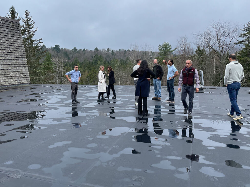 People standing on the rubber roof of the arts center.